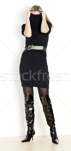 standing woman wearing black dress and fashionable boots Stock photo © phbcz