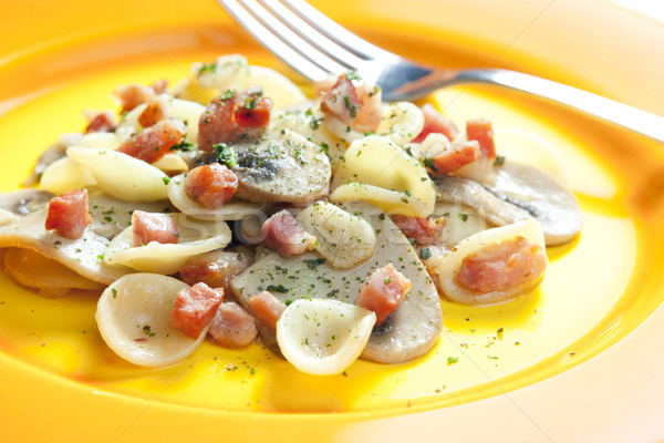 pasta orecchiette with bacon and champignons Stock photo © phbcz