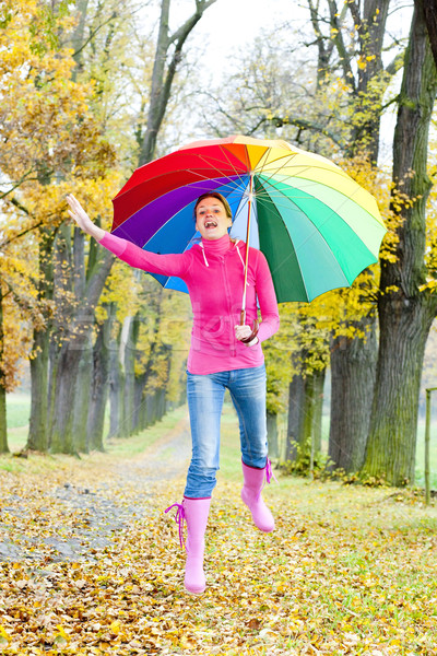 woman with an umbrella in autumnal alley Stock photo © phbcz