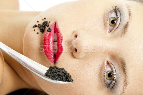 portrait of lying woman with black caviar Stock photo © phbcz