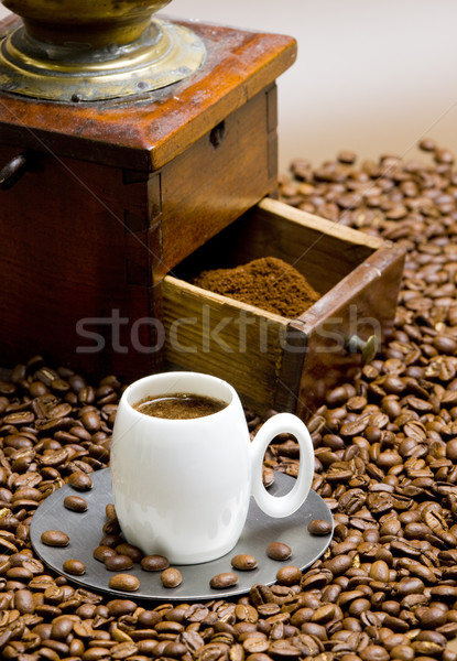 detail of coffee mill with coffee beans and cup of coffee Stock photo © phbcz