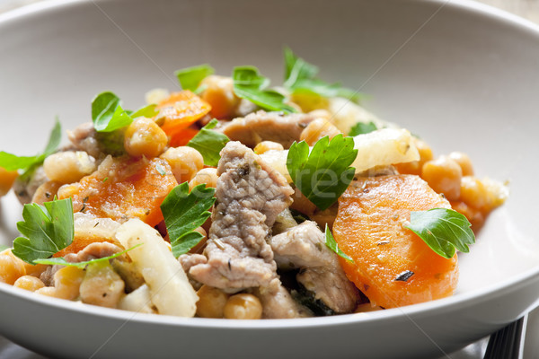 pork meat on celery with carrot and chick peas Stock photo © phbcz