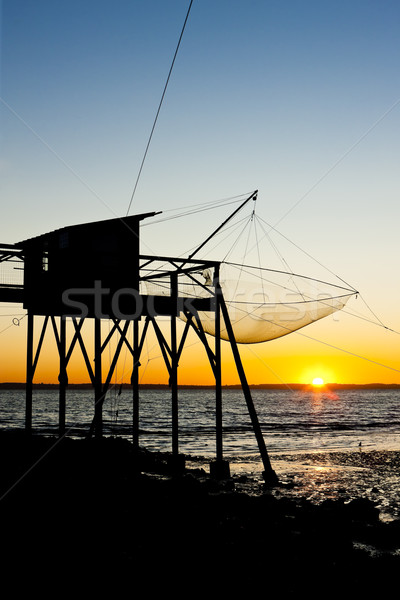 pier with fishing net during sunrise, Gironde Department, Aquita Stock photo © phbcz
