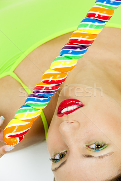 portrait of lying woman with a lollypop Stock photo © phbcz