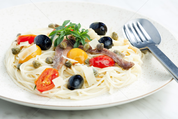 pasta with anchovies, capers and olives Stock photo © phbcz