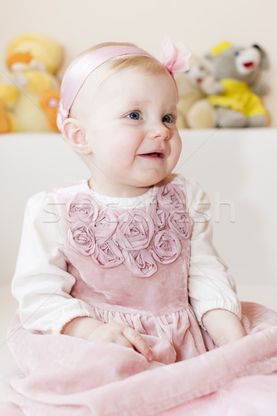 portrait of sitting toddler girl wearing pink dress Stock photo © phbcz