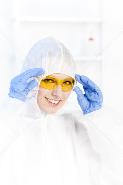 young woman with protective glasses and coat in laboratory Stock photo © phbcz