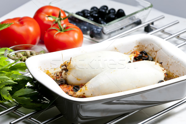 baked sepia with tomatoes and black olives filled with pearl bar Stock photo © phbcz