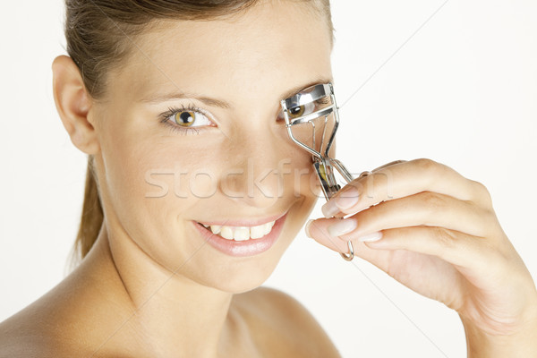 portrait of young woman making her eyelashes Stock photo © phbcz