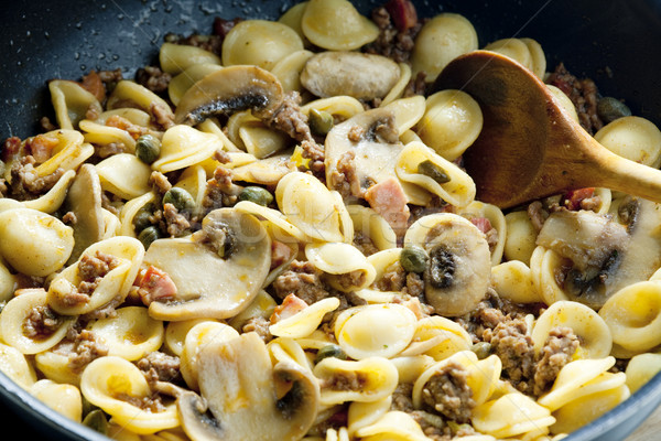 pasta orecchiette with bacon and champignons Stock photo © phbcz