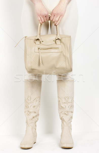 detail of standing woman wearing summer boots holding a handbag Stock photo © phbcz