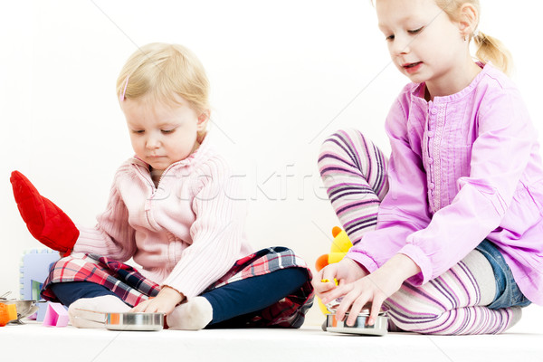 two little girls playing with child dish Stock photo © phbcz