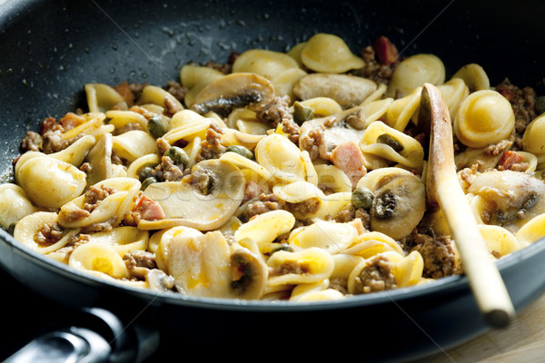 pasta orecchiette with bacon and champignons Stock photo © phbcz