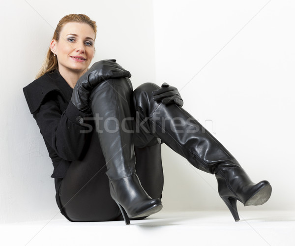 sitting woman wearing black clothes and boots Stock photo © phbcz
