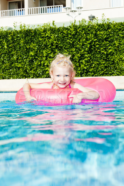 little girl with rubber ring in swimming pool Stock photo © phbcz