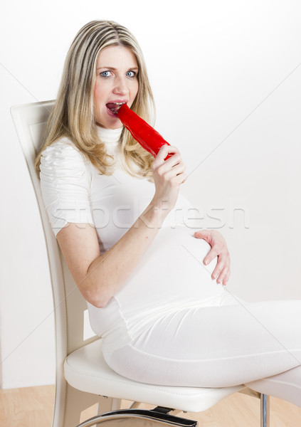 portrait of pregnant woman eating red pepper Stock photo © phbcz