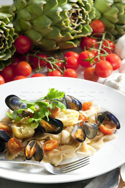 pasta with mussels, artichokes and cherry tomatoes Stock photo © phbcz