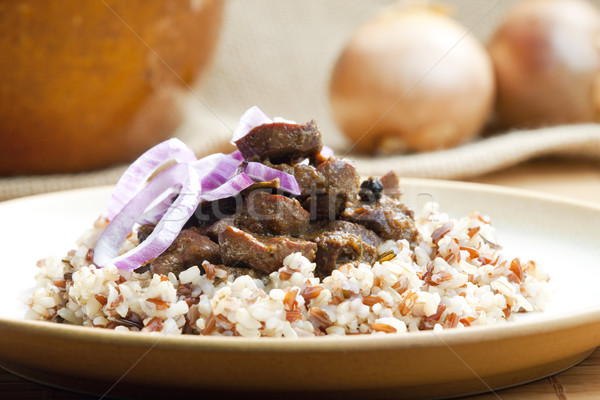 Stock photo: pork kidney on onion with wild rice