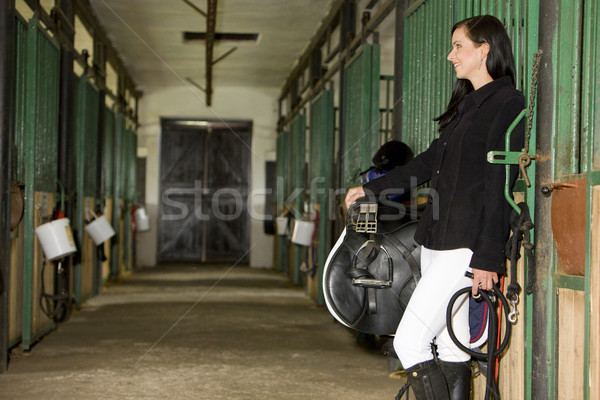 equestrian with saddle in a stable Stock photo © phbcz