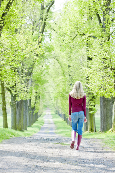 Mujer botas de goma primavera callejón árbol Foto stock © phbcz