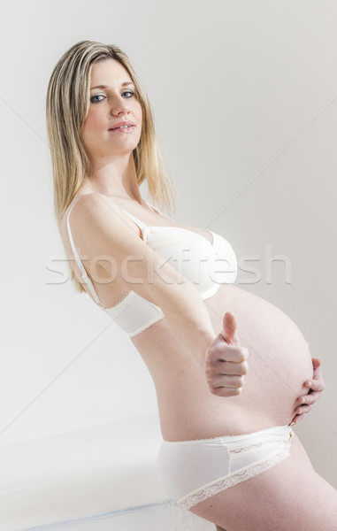 portrait of standing pregnant woman wearing lingerie Stock photo © phbcz