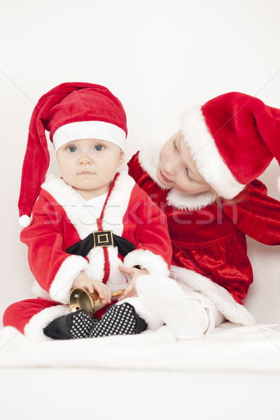 two little girls as Santa Clauses with a bell Stock photo © phbcz