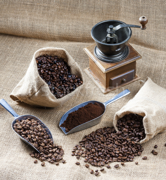 Stock photo: still life of coffee beans in jute bags with coffee grinder