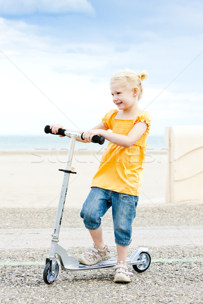 Stock photo: little girl with a scooter