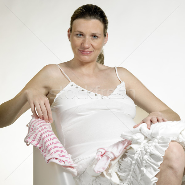 pregnat woman with clothes for babies Stock photo © phbcz