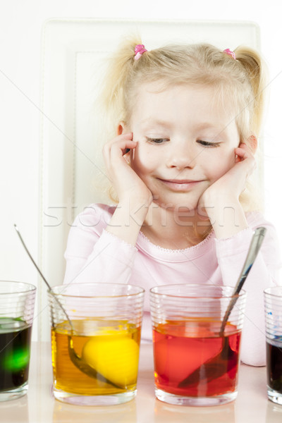 portrait of little girl during Easter eggs' coloration Stock photo © phbcz
