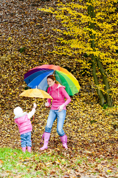 mother and her daughter with umbrellas in autumnal nature Stock photo © phbcz