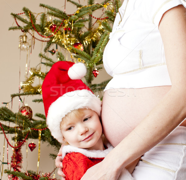 portrait of little girl and her pregnant mother by Christmas tre Stock photo © phbcz