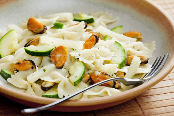 pasta farfalle with mussels and zucchini Stock photo © phbcz