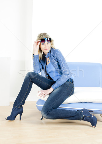 woman wearing blue clothes sitting on sofa Stock photo © phbcz