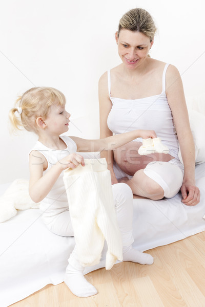 little girl and her pregnant mother with clothes and shoes for a Stock photo © phbcz