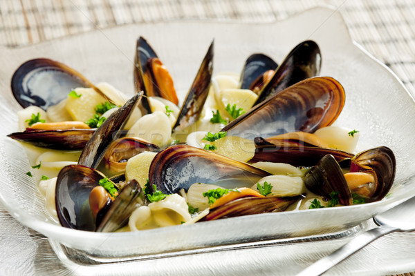 mussels soup with pasta orecchiette Stock photo © phbcz