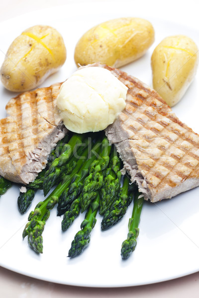 tuna steak with green asparagus and unpeeled potatoes Stock photo © phbcz