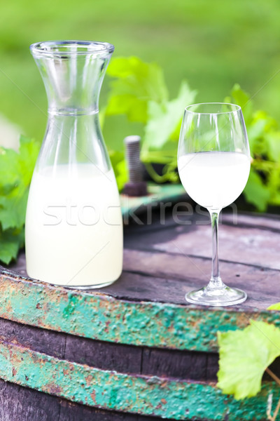 wine glass and carafe with wine cider standing on cask Stock photo © phbcz