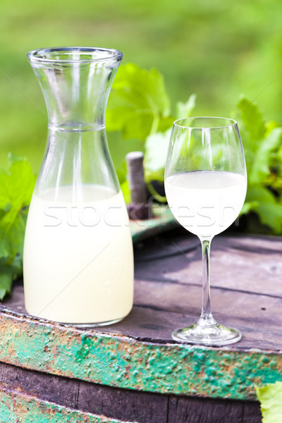 Stock photo: wine glass and carafe with wine cider standing on cask