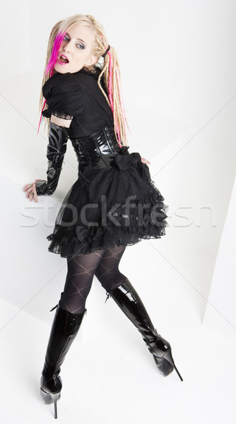 young woman with dreadlocks wearing extravagant clothes and boot Stock photo © phbcz