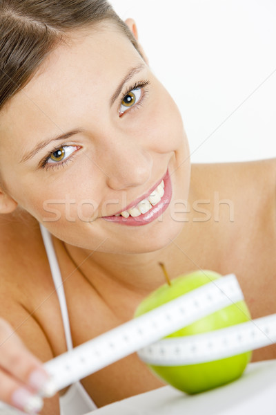 portrait of young woman with green apple and tape measure Stock photo © phbcz