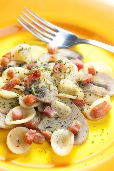 pasta orecchiette with bacon and champignons Stock photo © phbcz