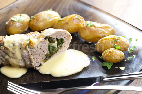 baked pork tenderloin filled with spinach and goat cheese on cre Stock photo © phbcz