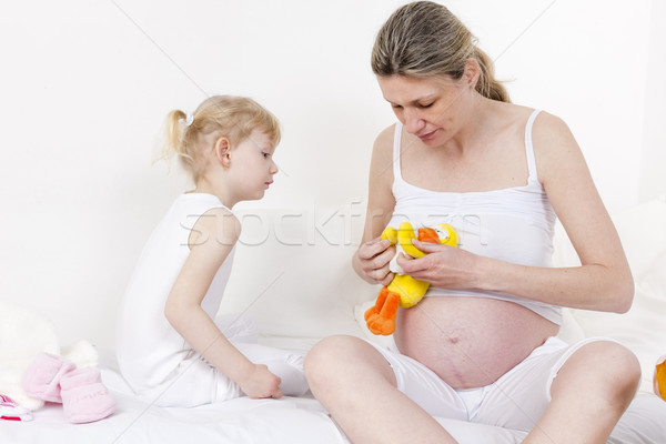 little girl and her pregnant mother with a toy for a baby Stock photo © phbcz