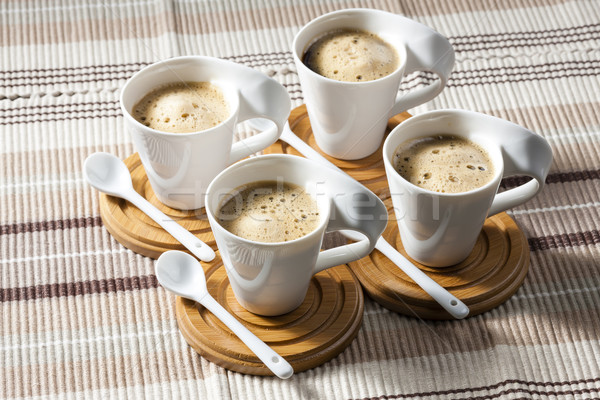 cups of coffee on place mats Stock photo © phbcz