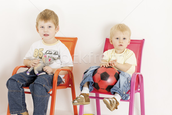 children sitting on chairs with toys Stock photo © phbcz
