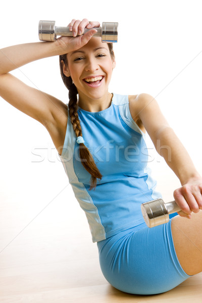 woman with dumb bells at gym Stock photo © phbcz