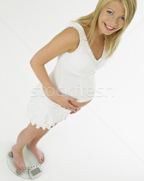 pregnat woman standing on weight scale Stock photo © phbcz