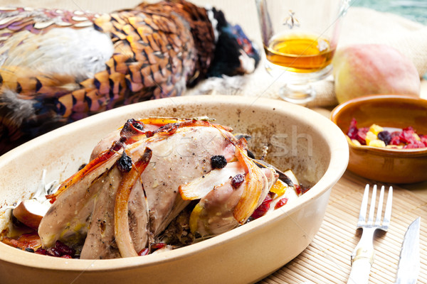 Stock photo: baked pheasant with bacon, pear, raisins on brandy