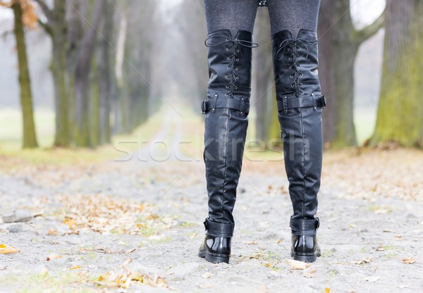 detail of woman wearing black clothes and boots in autumnal alle Stock photo © phbcz